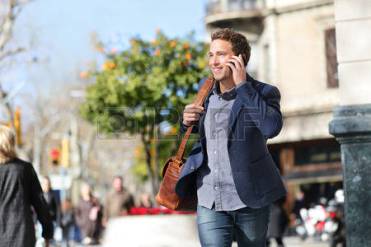 26735582-young-urban-businessman-on-smart-phone-running-in-street-talking-on-smartphone-smiling-wearing-jacke